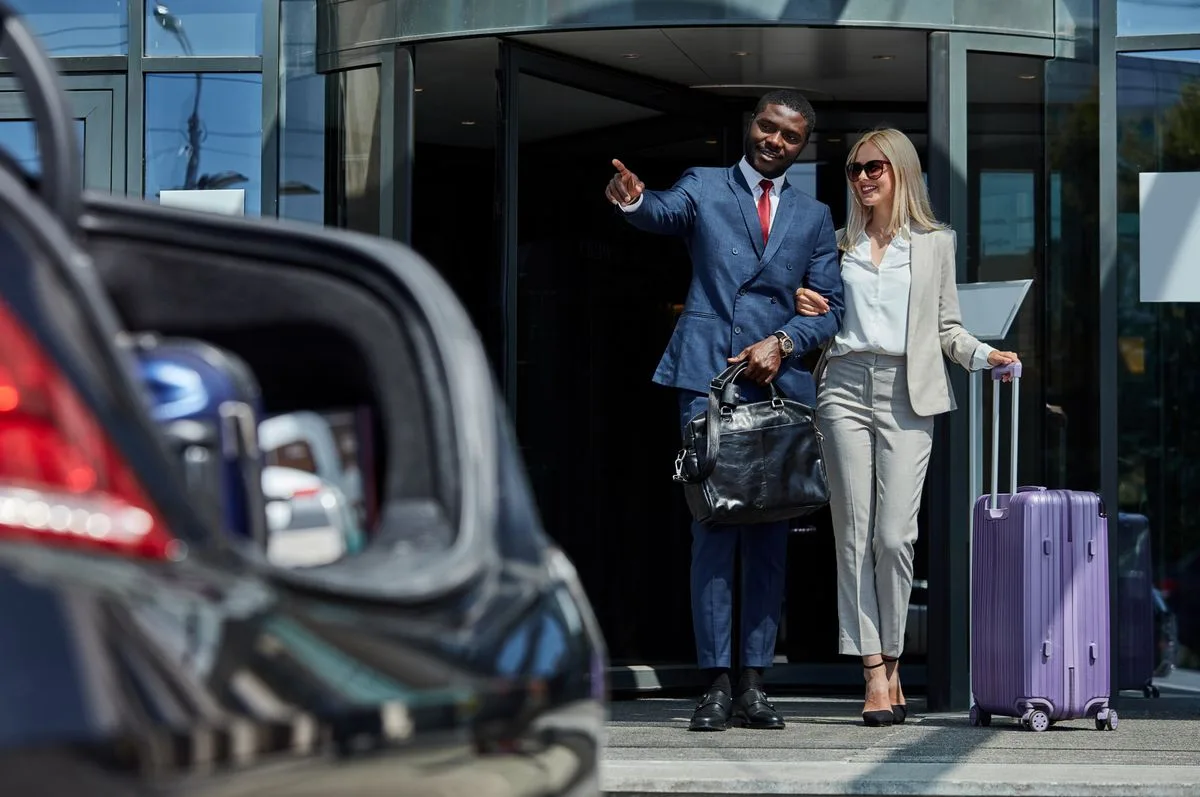 VIP couple with professional chauffeur at airport